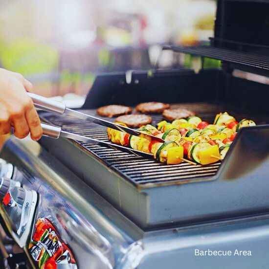 A person grilling vegetables at Barbecue Area, part of Godrej Sector 43 Gurgaon project.