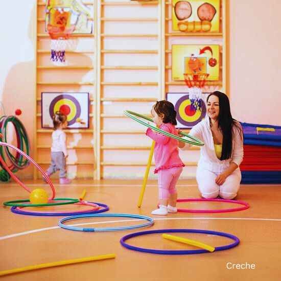 Mother and child are having fun with hula hoops in the indoor gaming zone at Godrej Sector 43 Gurgaon.